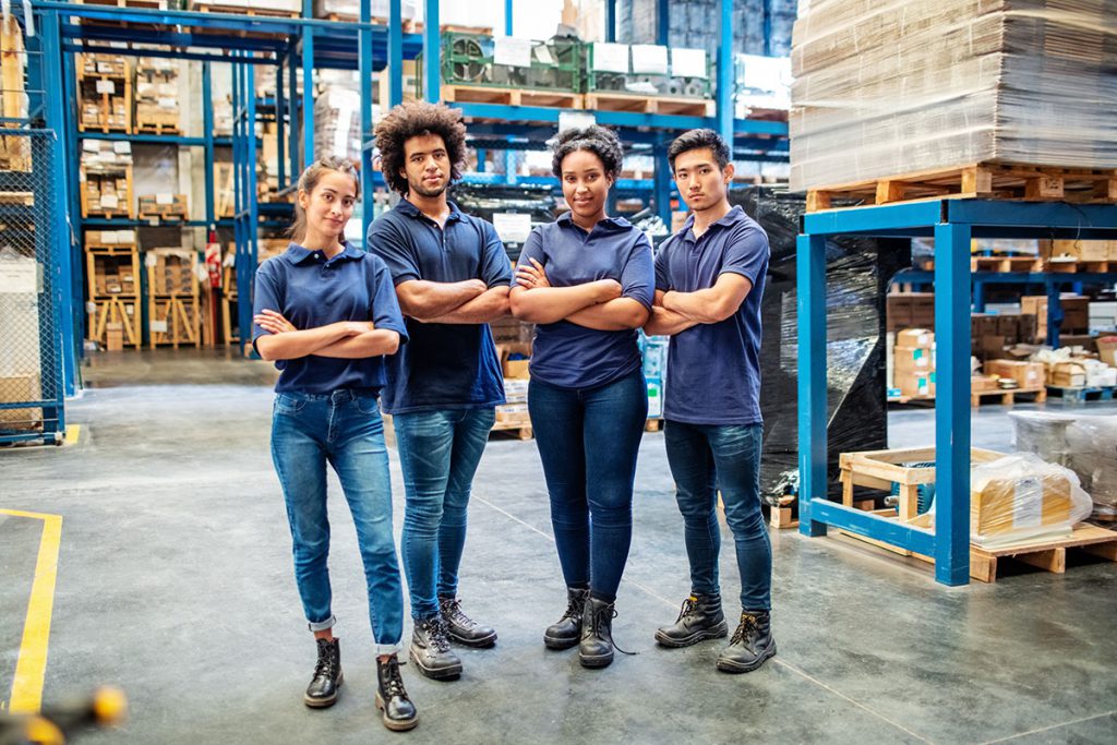 Four team players in the warehouse