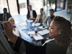 Black woman executive presents to colleagues