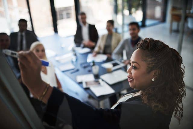 Black woman executive presents to colleagues