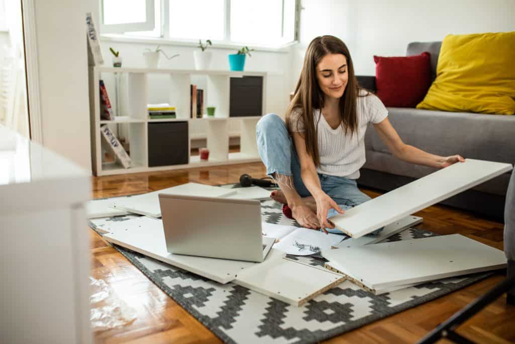 Woman assembling flat pack furniture.