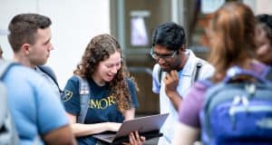 Students looking at laptop