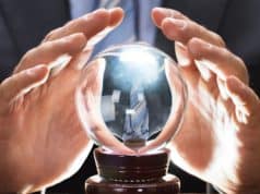 Hand holding crystal ball - Poets&Quants