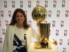 Goizueta BBA Grad Lauren Cohen posing with the NBA’s Larry O'Brien Championship Trophy