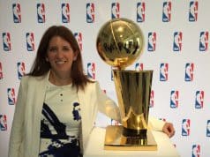 Goizueta BBA Grad Lauren Cohen posing with the NBA’s Larry O'Brien Championship Trophy