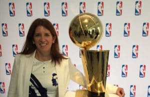 Goizueta BBA Grad Lauren Cohen posing with the NBA’s Larry O'Brien Championship Trophy