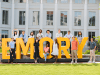 Students posing in and around the oversize Emory Letters on the lawn