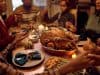 Family gathered around table at Thanksgiving