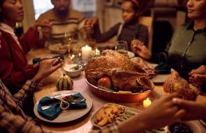 Family gathered around table at Thanksgiving