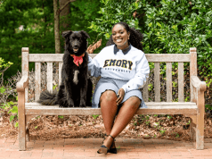Osereme Ujadughele on a bench with her dog