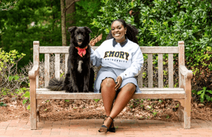 Osereme Ujadughele on a bench with her dog