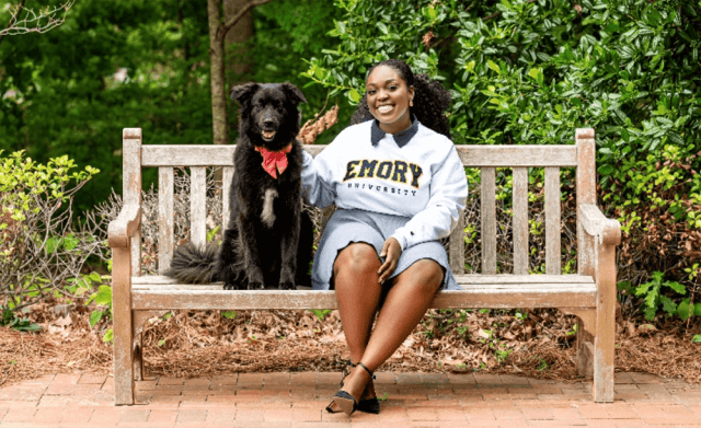 Osereme Ujadughele on a bench with her dog