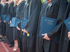 Goizueta grads holding diplomas