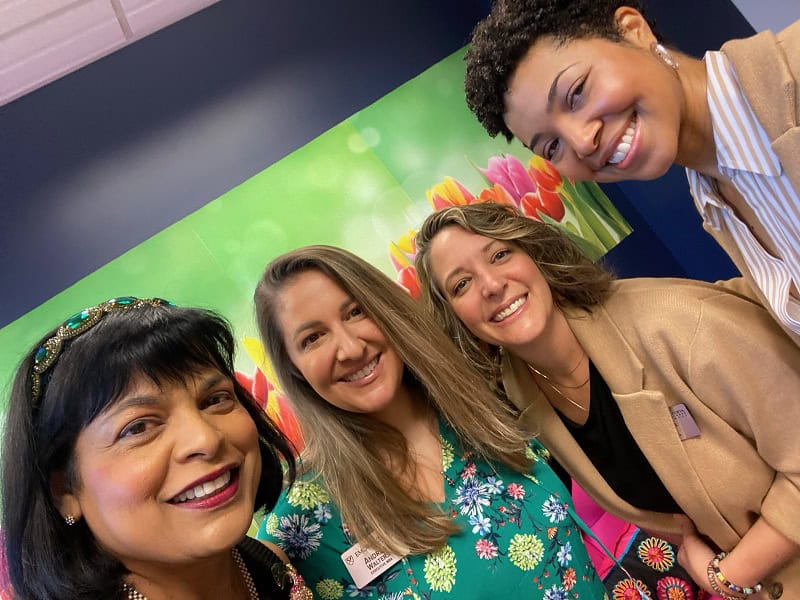 Goizueta's Tori DaCosta poses with faculty and fellow online MBA students.