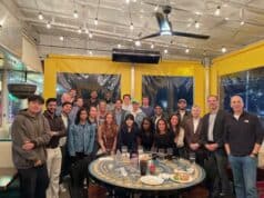 Leadership Development Fellows with faculty and executive coaches at a pizza gathering.