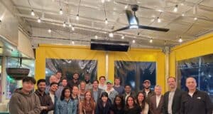 Learning Leadership by Doing: Inside the Leadership Development Fellows Course Leadership Development Fellows with faculty and executive coaches at a pizza gathering.