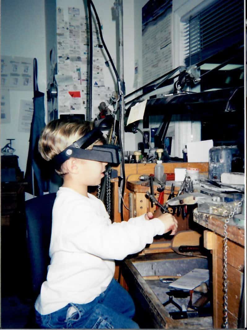Jonathan Geller as a child working at a jeweler’s bench in his family’s jewelry store.