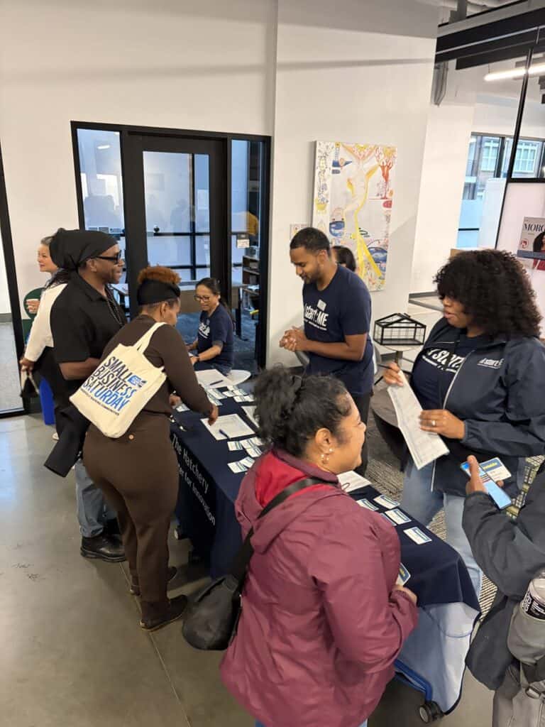 Entrepreneurs check in at a registration table during the Start:ME Accelerator kickoff event.