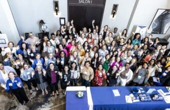 The roughly 300 attendees at Executive Women of Goizueta's 23rd Annual Leadership Conference, "Own your Own Path: Ignite, Elevate, Lead” gather for a group shot at Emory University.