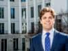 A headshot of Goizueta BBA Grant Huddleston standing outside of the business school building