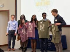 Clarkston Giving Week(end): Students Driving Community Impact Through Action Co-instructors Brian Goebel and Tene Traylor presenting the student leadership team with Clarkston t-shirts.