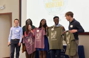 Co-instructors Brian Goebel and Tene Traylor presenting the student leadership team with Clarkston t-shirts.