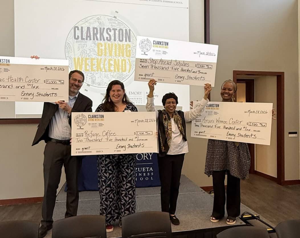 Each of the four participating nonprofits receiving their grant award.